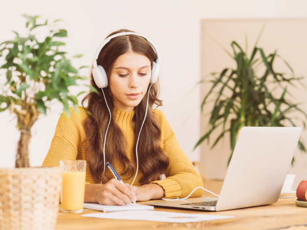 Female working from home while using noise-cancelling headphones
