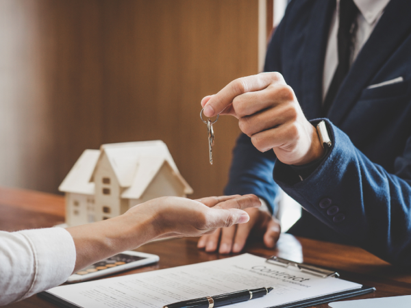 Landlord giving tenant key to the house