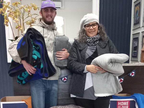 Man and woman smiling and supporting Seeff Blanket Drive 2023