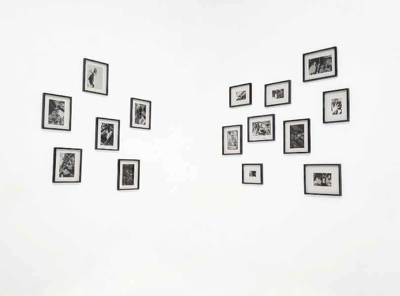 black and white pictures framed against white wall
