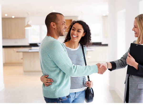 buyers shaking hands with property practitioner to seal deal on investment property