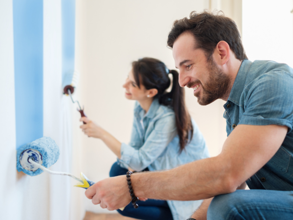 couple-painting-home-with-blue-paint