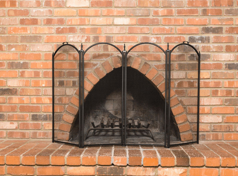 brick fireplace with fireplace screen infront