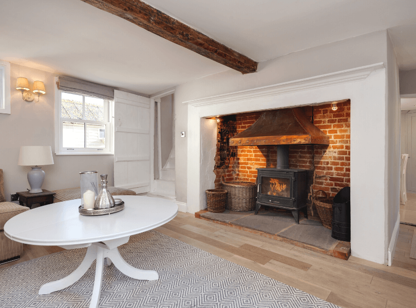 spacious living room with brick walled iron fireplace