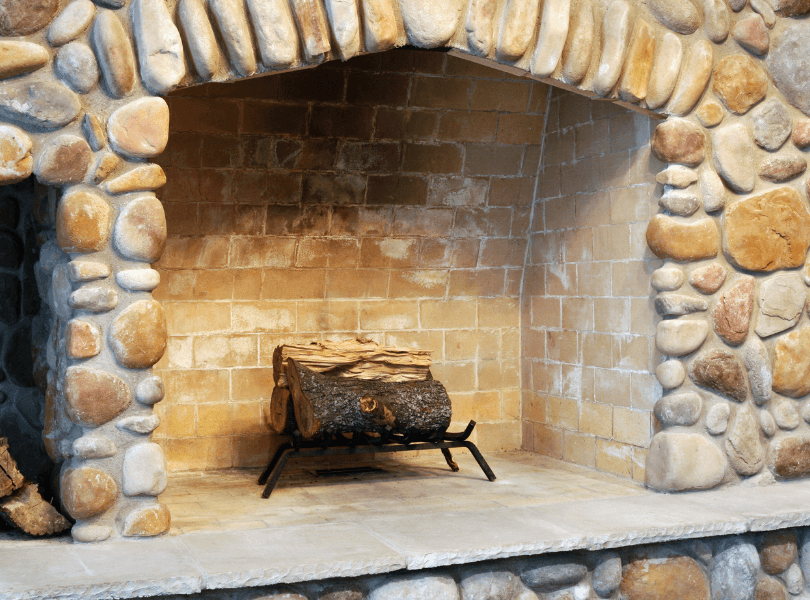 stone fireplace with log in centre
