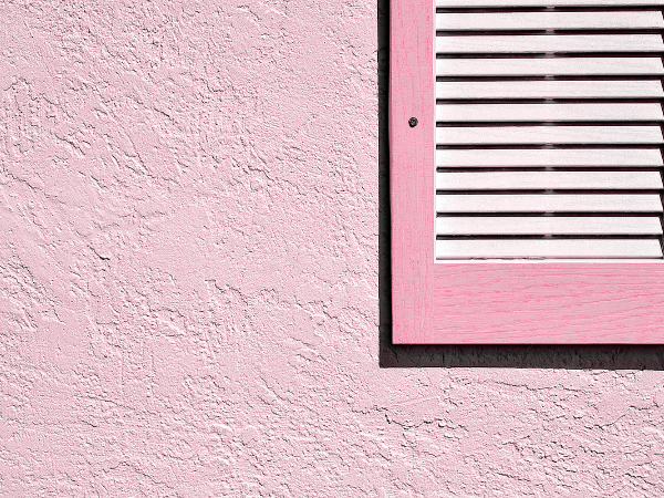 home exterior with whimsical pink wall and window frame