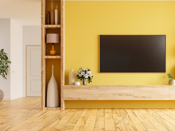 iving room with yellow statement wall and tv screen 