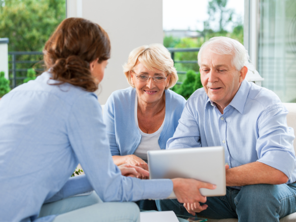 real estate agent discussing interest rate hike with senior couple