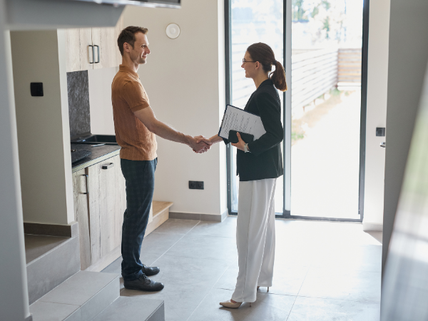 real estate agent shaking hands with new property owner