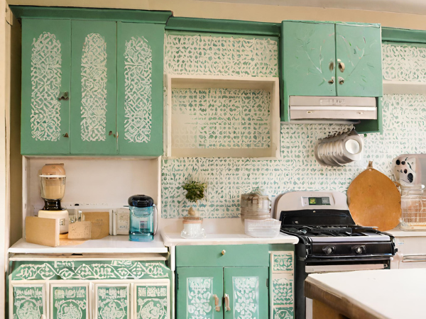 retro kitchen cupboards with stencilled art and round handles