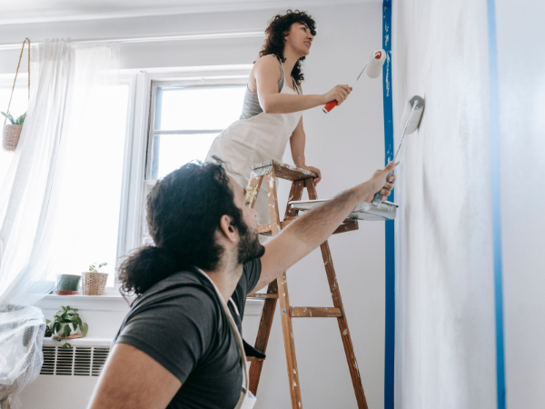 Couple repainting their walls for home staging