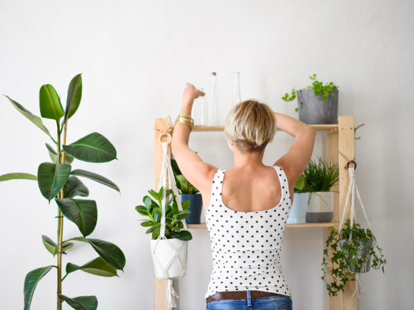 woman decorating new rented house with plants