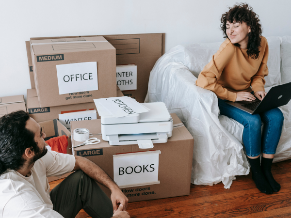 young couple packing moving boxes
